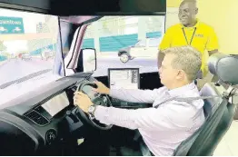  ?? CONTRIBUTE­D ?? Managing Director of Carreras Limited, Franklin Murillo tests his driving skills on JAA’s virtual simulator, supervised by JAA driving instructor, Anthony Robinson.