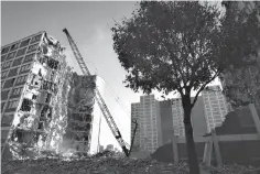  ?? Associated Press ?? ■ In this Nov. 8, 1995, file photo, a wrecking ball tears away at one of several Cabrini-Green public housing project buildings in Chicago.