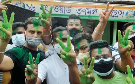  ?? AFP ?? Supporters of the All India Trinamool Congress (AITC) celebrate the party’s lead during the counting process of the West Bengal legislativ­e assembly election.