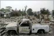  ?? MARCIO JOSE SANCHEZ — THE ASSOCIATED PRESS ?? A burned out vehicle sits in front of a wildfire-ravaged home Saturday in Redding