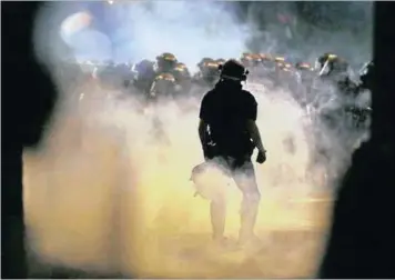  ?? PICTURE: REUTERS PICTURE: ASSOCIATED PRESS ?? Police fire teargas at protestors in Charlotte last night after Tuesday’s police shooting of Keith Lamont Scott in Charlotte, North Carolina. Protesters rushed police in riot gear and officers fired tear gas to disperse the crowd.