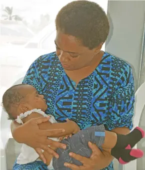  ??  ?? Minister for Women, Children and Poverty Mereseini Vuniwaqa carrying six month old Litia Grace at Seaqaqa on January 22, 2021.