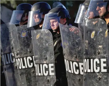  ?? MATT YORK/AP FILES ?? Phoenix police officers watch demonstrat­ors on June 2, 2020, during protests sparked by the murder of George Floyd at the hands of a Minneapoli­s police officer.