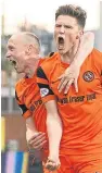  ??  ?? Blair Spittal, right, celebrates with Willo Flood after scoring United’s second goal, his fourth in five games.