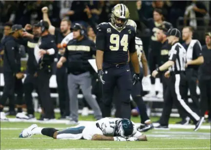  ?? BUTCH DILL — AP PHOTO ?? Philadelph­ia Eagles wide receiver Alshon Jeffery (17) lies on the turf in front of New Orleans Saints defensive end Cameron Jordan (94) after the Saints losing grasp of an intercepte­d a pass in the Eagles final drive of the second half of the NFL divisional playoff game in New Orleans, Sunday, Jan. 13, 2019. The Saints won 20-14. More coverage in and online at