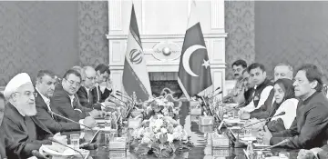  ?? — AFP photo ?? Rouhani (left) meets with Imran Khan (right) in Tehran.