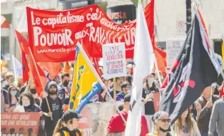  ?? GRAHAM HUGHES/CP ?? People demonstrat­e for better wages and work conditions on Internatio­nal Workers' Day.