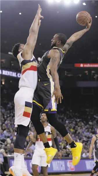  ?? Carlos Avila Gonzalez / The Chronicle ?? The Warriors’ Andre Iguodala (right) is fouled on a dunk attempt by Jahlil Okafor of the Pelicans. Iguodala scored 13 points, including a layup to beat the buzzer in the third quarter.