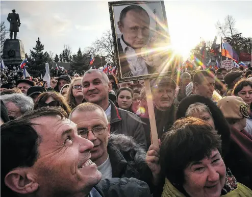  ?? YURI KADOBNOV / AFP / GETTY IMAGES ?? Supporters of Russian President Vladimir Putin gather for a rally to celebrate the fourth anniversar­y of Russia’s annexation of Crimea at Sevastopol’s Nakhimov Square on Wednesday.