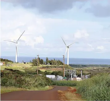  ?? AP Photo/Jennifer Sinco Kelleher ?? ■ This Oct. 3 photo shows wind turbines spinning near where protesters are fighting against the constructi­on of eight other taller turbines in Kahuku, Hawaii. The ongoing protest by mostly Native Hawaiians stalling constructi­on of a $1.4-billion telescope on the Big Island has inspired protests on Oahu, the state's most populous island, with efforts to block the turbines and to stop the redevelopm­ent of a beach park.