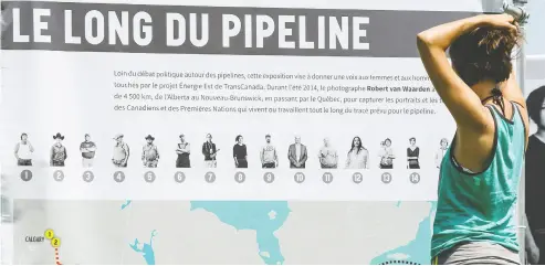  ?? FREDERIC HORE / POSTMEDIA NEWS FILES ?? A Montrealer looks at a map of the proposed Energy East pipeline at a 2015 rally organized by Greenpeace in Hudson,
Que. The province’s residents might be more welcoming of energy projects, according to a recent poll.