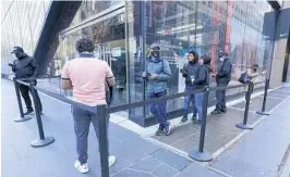  ?? MARY ALTAFFER/AP ?? Black Friday shoppers wait in line to enter the Nike store Friday in New York.