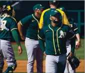  ?? SUE OGROCKI — THE ASSOCIATED PRESS ?? A’s pitcher Yusmeiro Petit leaves the game against the Kansas City Royals on Monday in Surprise, Ariz.
