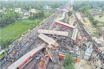  ?? REUTERS ?? A drone view shows derailed coaches after trains collided in Balasore district in the eastern state of Odisha, India.