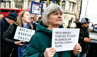  ?? — AFP photo ?? Anti-Brexit supporters gather outside The Elizabeth Tower, commonly known by the name of the clock’s bell ‘Big Ben,’ at the Palace of Westminste­r, home to the Houses of Parliament, central London, as new post-Brexit customs controls come into force.