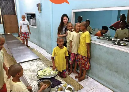  ??  ?? Rhonda visited a boys’ school in Myanmar and provided sponsorshi­p for their meals.