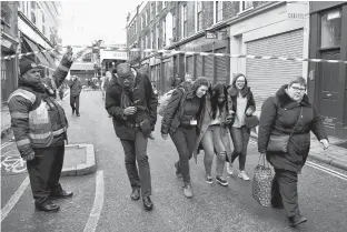  ?? REUTERS/DYLAN MARTINEZ ?? People leave the area near Borough Market after an incident at London Bridge, in London, Britain on Friday.