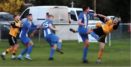  ?? Picture: Peter Langley ?? Action from Wick’s goalless draw at Frampton United (blue and white shirts) in the Gloucester­shire County League last Saturday