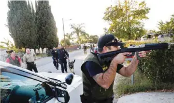  ??  ?? SAN BERNARDINO: This file photo taken on December 2, 2015 shows Law enforcemen­t officers searching for the suspects of a mass shooting. — AFP