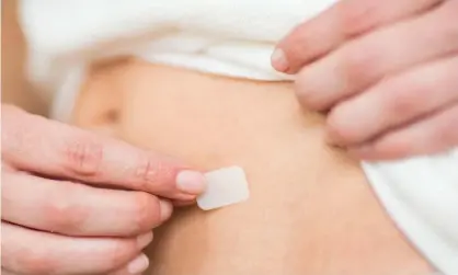  ?? Photograph: Phanie/ Alamy ?? ‘I was simply told to see my GP at some point to discuss hormone replacemen­t.’ A woman applying an HRT patch.