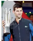  ??  ?? Novak Djokovic celebrates with the trophy