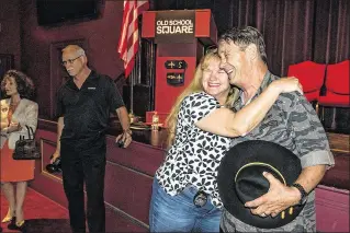  ?? PHOTOS BY MICHAEL ARES / THE PALM BEACH POST ?? Retired Delray Beach police officer Skip Brown gets a hug from Palm Beach Gardens Public Informatio­n Officer Ellen Lovejoy after Tuesday’s ceremony at the Crest Theater. Brown was awarded the medal for his actions in a Feb. 29, 1972, firefight with the...