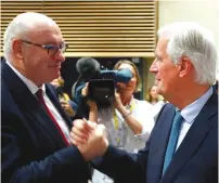  ?? (Francois Lenoir/Reuters) ?? PHIL HOGAN, European Trade Commission­er-designate, greets EU’s chief Brexit negotiator Michel Barnier at the European Council building in Brussels yesterday.