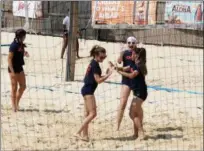  ?? JONATHAN TRESSLER — THE NEWS-HERALD ?? Teammates celebrate after making a play July 10 during a sand volleyball summer camp session at Force Sports in Eastlake.