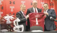  ?? MATT ROURKE/AP ?? Rod Carey (center) coached in parts of seven seasons at Northern Illinois, leading the Huskies to six bowl games (all losses) and compiling a 52-30 record.