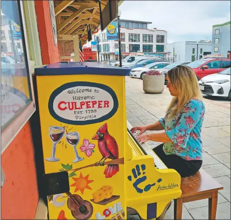  ?? (The Star-Exponent/Emily Jennings) ?? Culpeper piano teacher Brittany Bache, a Blue Ridge Chorale accompanis­t, plays Culpeper’s first public piano after it’s unveiled outside the town Visitor Center in Culpeper Va.