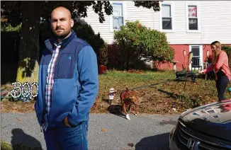  ?? MICHAEL DWYER/ AP ?? Shad Elia stands outside one of his 24 single- family Boston- area apartments as tenant Krystal Dinglerwal­ks her dog. Stimulus benefits allowed hard- hit tenants to continue to pay rent. But with those benefits expired and tenants falling behind, Eliawonder­s howmuch longer his lenders will cut him slack.