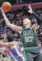  ?? Carlos Osorio / Associated Press ?? Celtics forward Daniel Theis had 14 points and seven rebounds before halftime. He finished with 17 points and eight rebounds against Detroit.
