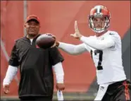  ??  ?? Brock Osweiler looks to throw as head coach Hue Jackson watches at a June practice in Berea. Osweiler will start the Browns’ preseason opener Aug. 10 against the Saints.