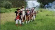  ??  ?? The 1st Delaware Regiment fires muskets on the 241st anniversar­y of the Battle of Brandywine.