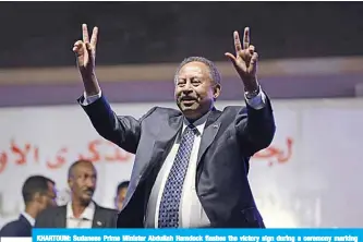  ??  ?? KHARTOUM: Sudanese Prime Minister Abdullah Hamdock flashes the victory sign during a ceremony marking the first anniversar­y of the uprising that toppled Omar Al-Bashir, in Khartoum on December 25. —AFP