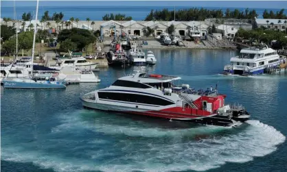  ?? Photograph: Gary Cameron/Reuters ?? A passenger ferry leaves Royal Naval Dockyard near Hamilton in Bermuda.