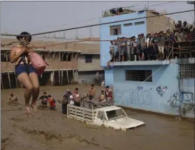  ?? AP PHOTO/MARTIN MEJIA ?? ABOVE RIGHT: A woman is pulled to safety in a zipline harness in Lima, Peru, on Friday.