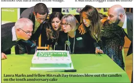  ??  ?? Laura Marks and fellow Mitzvah Day trustees blow out the candles on the tenth anniversar­y cake