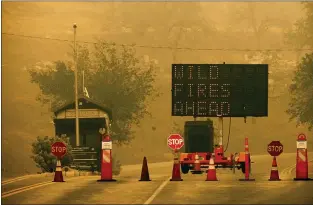  ?? NOAH BERGER — THE ASSOCIATED PRESS ?? Cones block the entrance to Sequoia National Park as the KNP Complex Fire burns nearby on Wednesday. The blaze was burning near the Giant Forest, home to more than 2,000 giant sequoias.