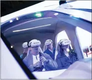  ?? JOAN MATEU PARRA — THE ASSOCIATED PRESS ?? Visitors test a SK Telecom VR flight simulator during the Mobile World Congress 2023in Barcelona, Spain, Monday.