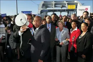  ?? KEVIN GLACKMEYER — THE ASSOCIATED PRESS FILE ?? In this March 4, 2012, file photo, U.S. Rep. John Lewis, D-Ga., center, talks with those gathered on the historic Edmund Pettus Bridge during the 19th annual reenactmen­t of the “Bloody Sunday” Selma to Montgomery civil rights march across the bridge in Selma, Ala.