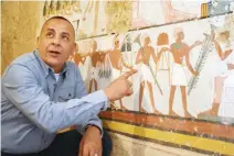  ??  ?? Mustafa Al-Waziri, director general of Luxor’s Antiquitie­s, points at an ancient Egyptian mural found at a newly discovered tomb in Luxor, about 650 km south of Cairo. (AFP)