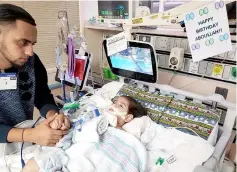  ??  ?? File photo courtesy of the Council on American-Islamic relations in Sacramento shows the young Abdullah Hassan on life support at UCSF Benioff Children’s Hospital in Oakland, California with his father, Ali. — AFP photo