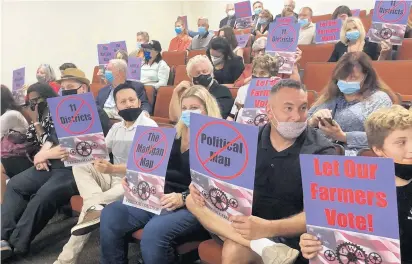  ?? MICHELLE MULLINS/DAILY SOUTHTOWN ?? Residents at Monday’s Will County Board public hearing protest dividing the county into 11 board districts, saying it is a political map that disenfranc­hises farmers.