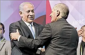  ?? CHIP SOMODEVILL­A/GETTY PHOTO ?? Israeli Prime Minister Benjamin Netanyahu, left, greets AIPAC leader Howard Kohr on Tuesday. Addressing the group, Netanyahu talked at length about Iran’s nuclear program.