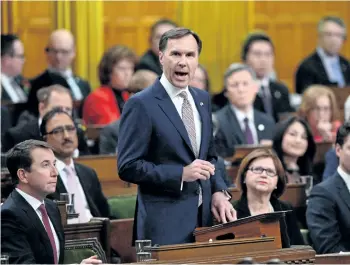  ?? THE CANADIAN PRESS FILES ?? Finance Minister Bill Morneau says a $4 billion dividend to be paid by CMHC is a sign of how well the Crown Corporatio­n is managing its businesses.