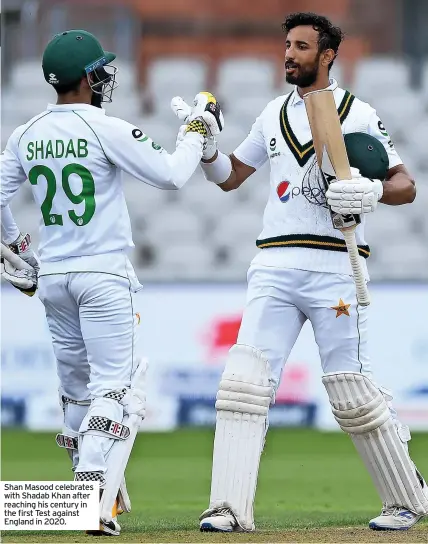  ?? ?? Shan Masood celebrates with Shadab Khan after reaching his century in the first Test against England in 2020.