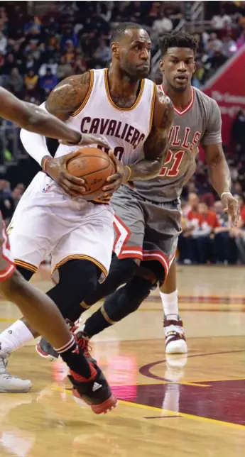  ?? KEN BLAZE/USA TODAY SPORTS ?? The Cavaliers’ LeBron James drives past the Bulls’ Jimmy Butler during action Saturday night in Cleveland.