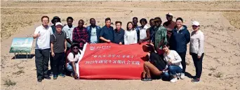  ?? ?? A research team from China Agricultur­al University pose for a group photo at the Laohukou Desertific­ation Prevention and Demonstrat­ion Area in Gansu Province on 21 July