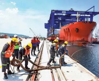  ?? ?? The ship carrying container-handling cranes being docked at the Vizhinjam port on Tuesday.